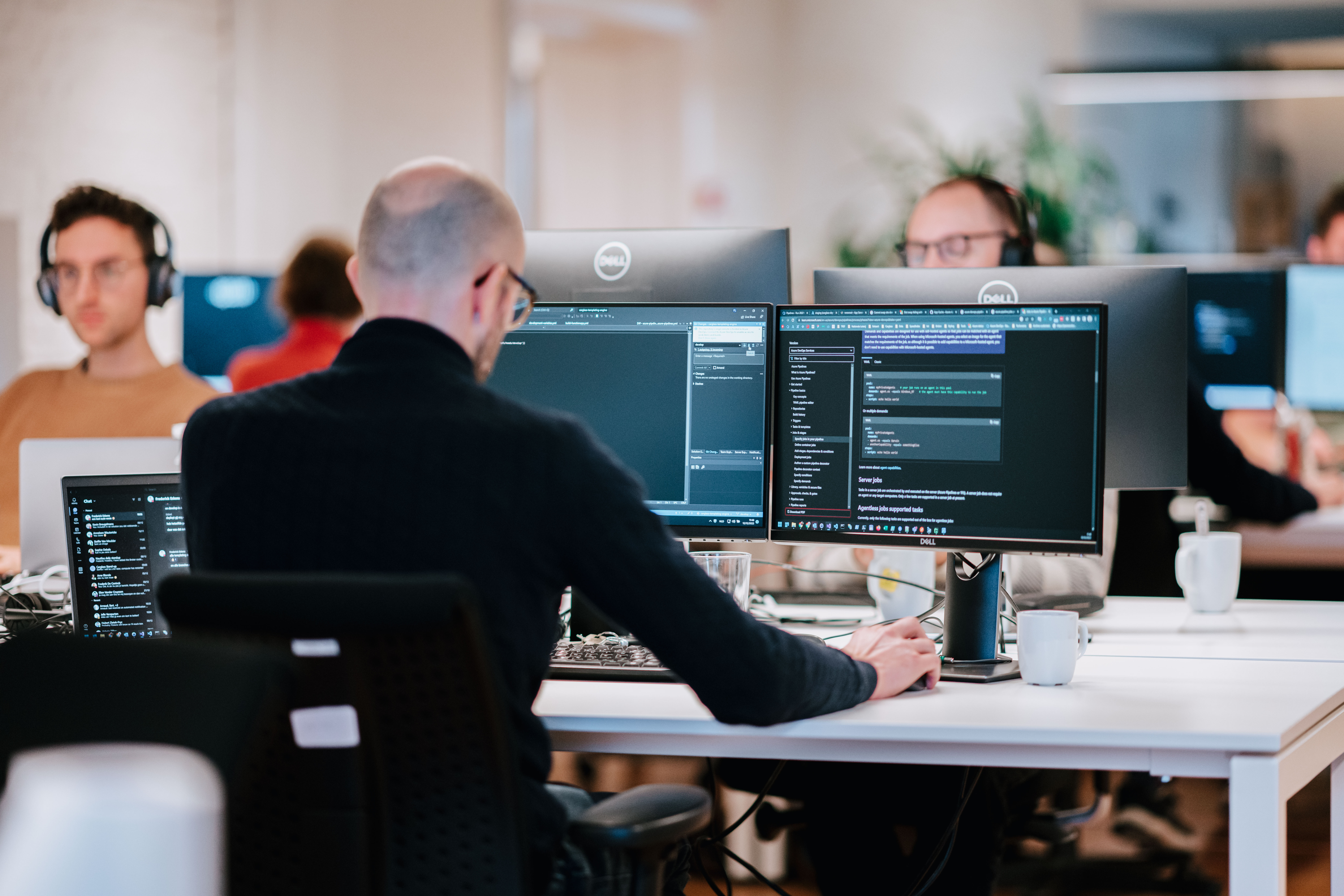 A person working on multiple computer screens