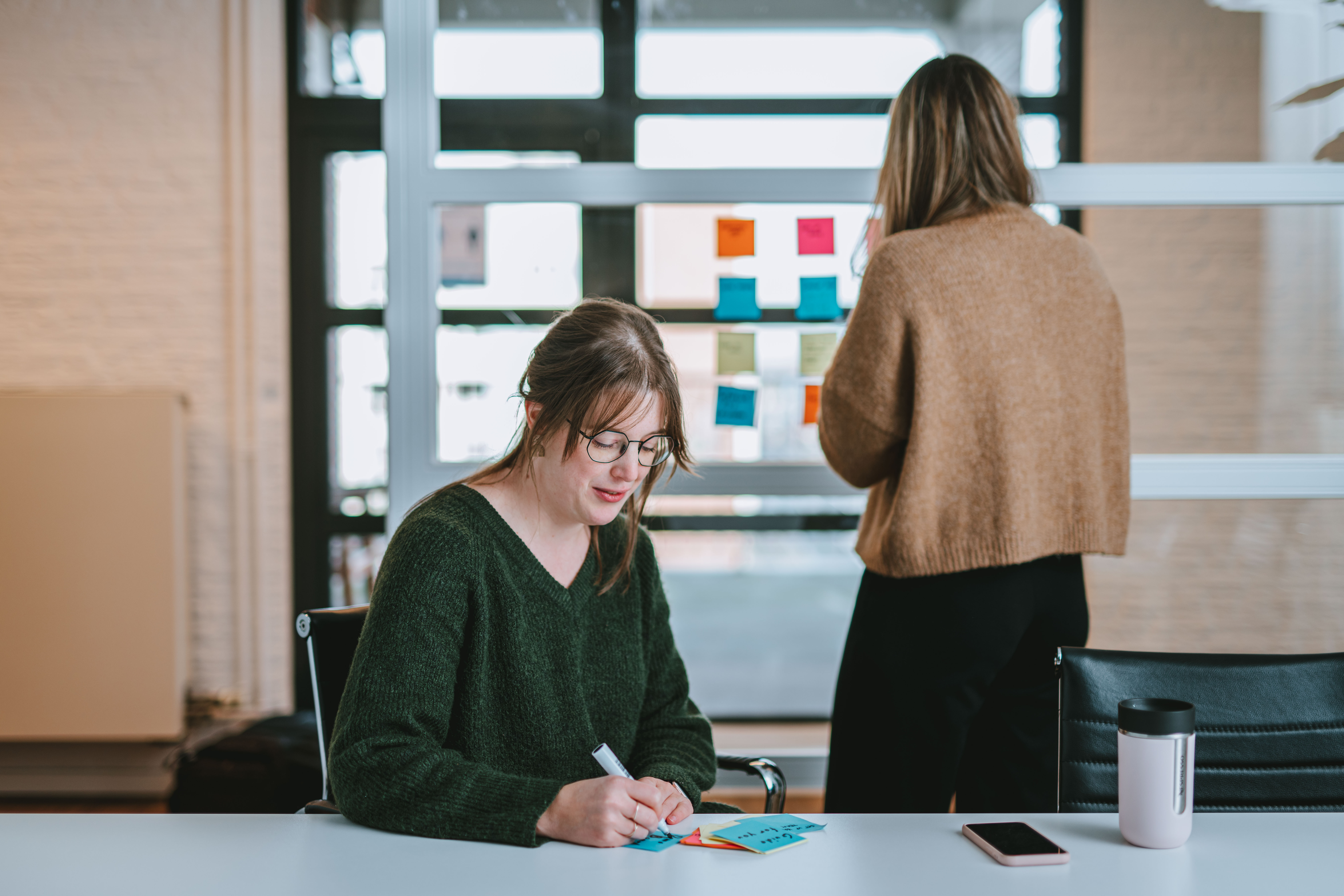 Person writing on a post-it