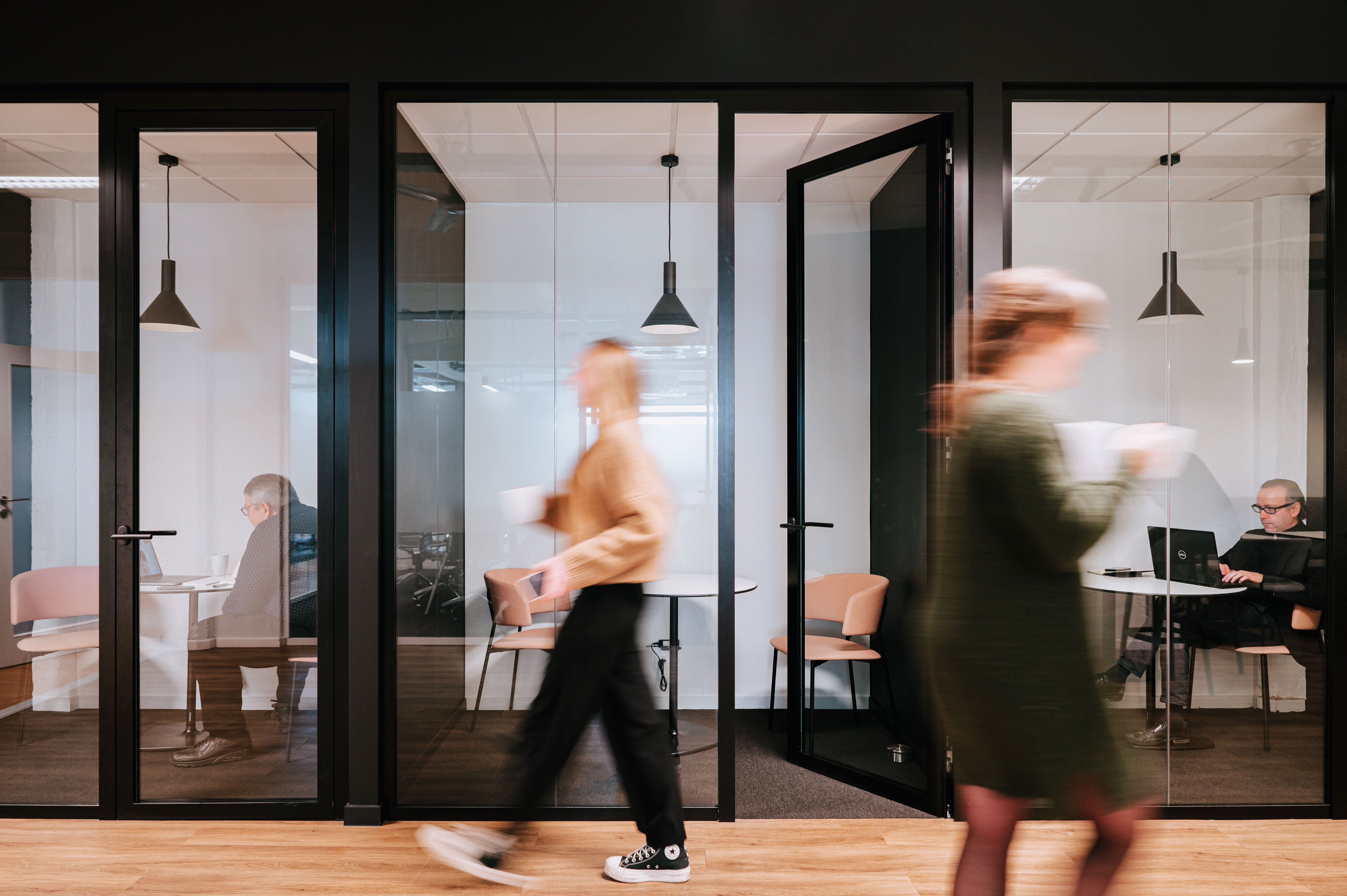 Wide shot of people walking past the silent booths
