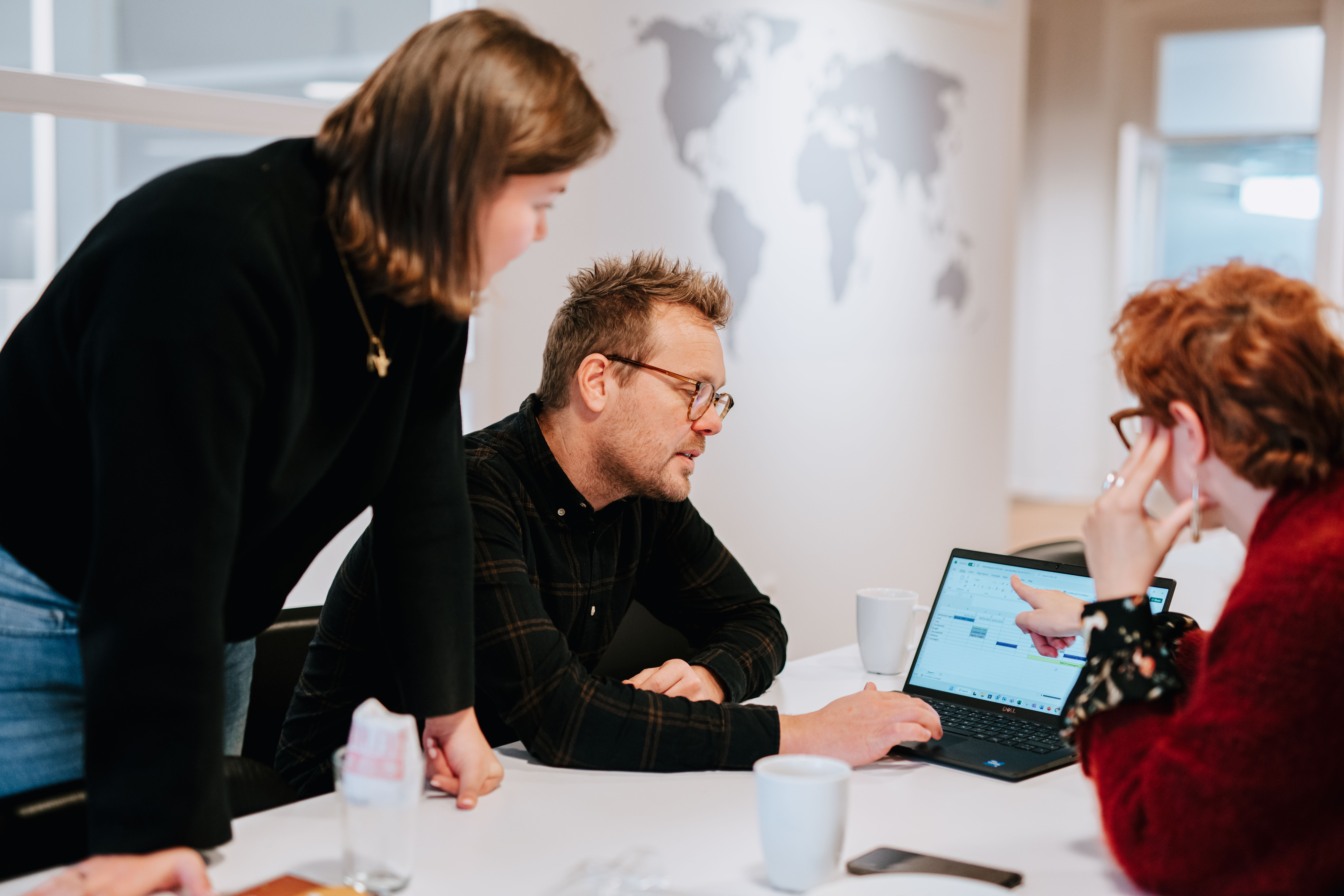Three people having a casual meeting in the kitchen