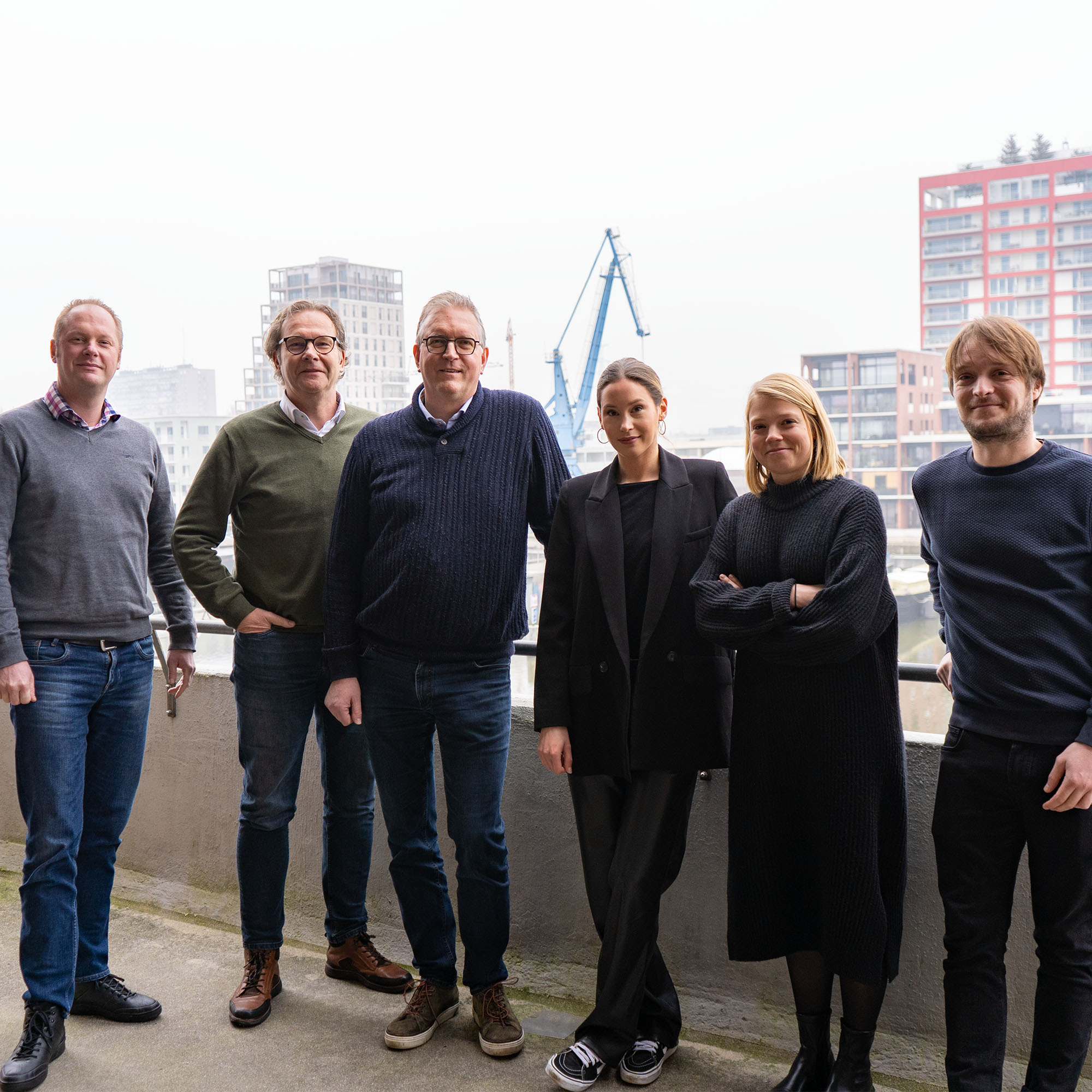 Mennens employees together with the team from The Reference on the balcony at the Ghent office