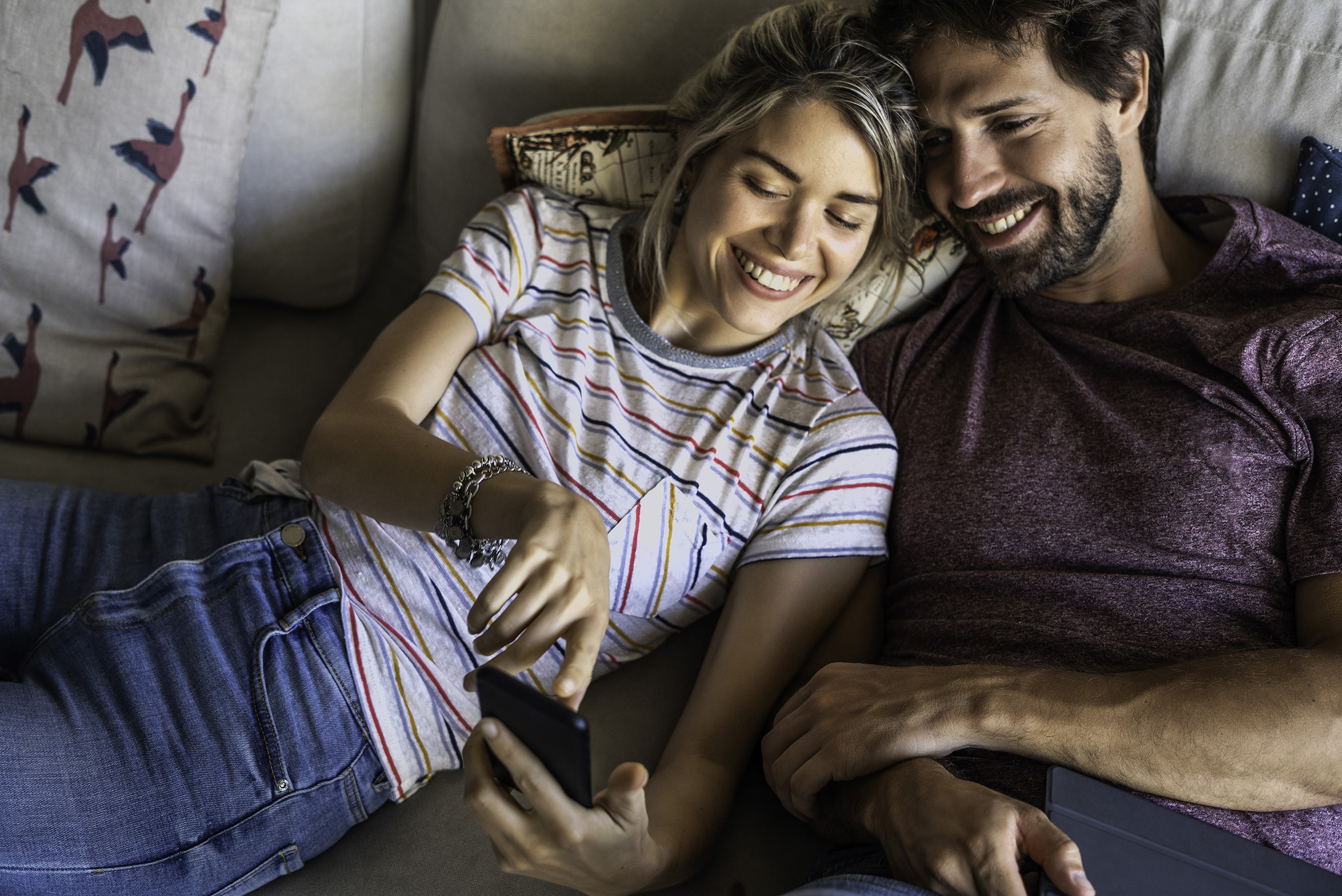 People on couch using DELA app