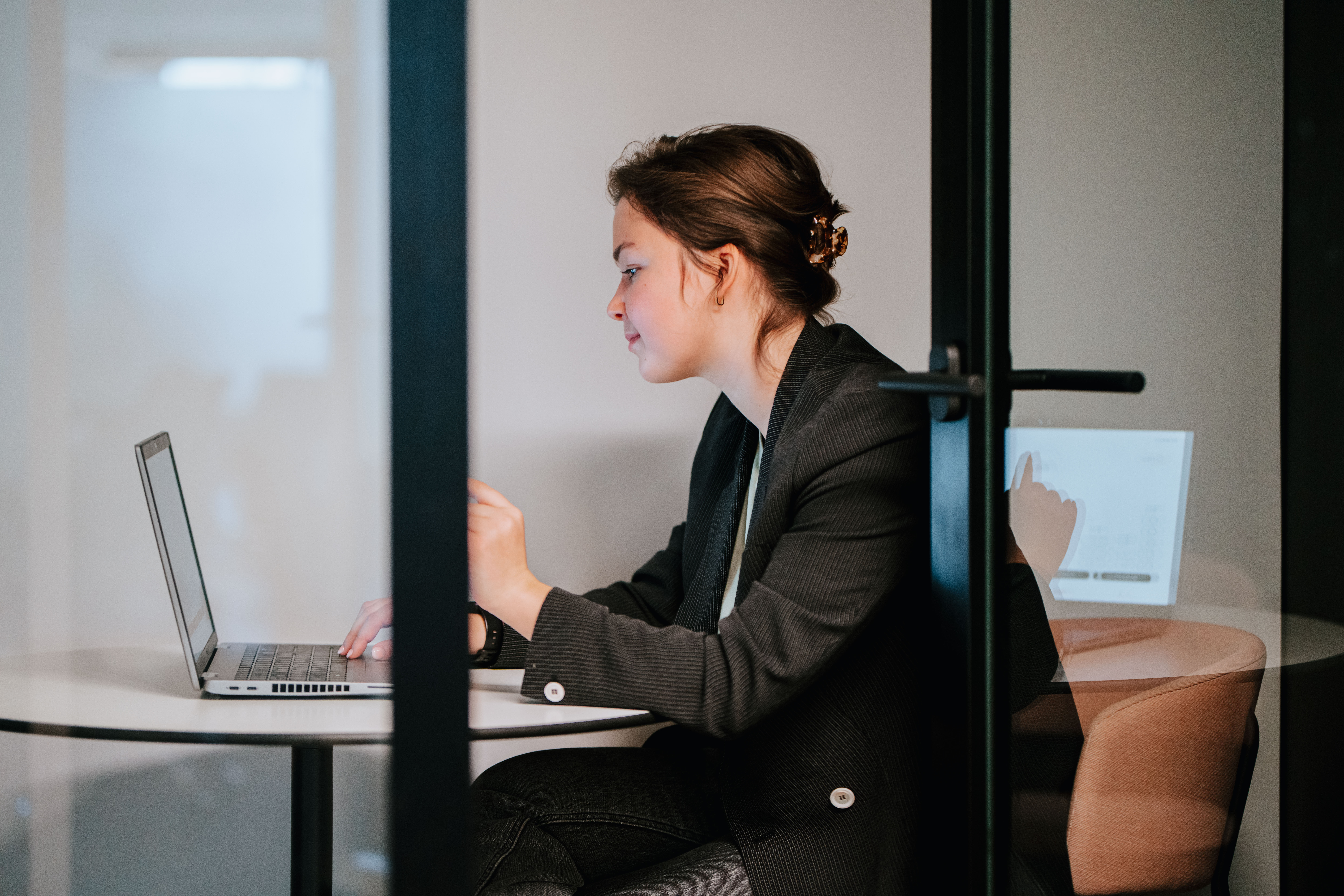 A person working in concentration in a silent booth